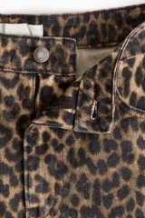 Jean de tiro alto y diseño barrel con volumen curvo en las piernas y largo tobillero, confeccionado en denim de algodón con estampado animal print de leopardo.