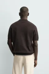 Polo de punto de algodón con corte regular, cuello solapa y cierre frontal de cremallera. Presenta manga corta y acabados en rib.