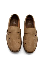 Zapato tipo mocasín de estilo urbano, color gris, confeccionado en eco-cuero con perforaciones laterales para ventilación. Presenta costuras reforzadas en el contorno de la suela y un cierre lateral con velcro para un ajuste práctico.