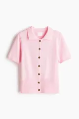 Saco de manga corta confeccionado en punto suave, con cuello camisero, cierre frontal de botones y remate acanalado en puños y bajo.