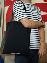 Bolso tote negro de algodón con doble asa y logo Jack & Jones estampado en blanco en la parte inferior.