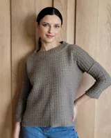 Sweater de punto color verde claro con textura tipo waffle, cuello redondo y mangas 3/4.