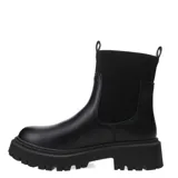 Botas Chelsea de mujer color nude (beige claro) con caña de tejido elástico negro acanalado. Posee suela track gruesa y dentada de goma negra y tirador trasero de tela negra.