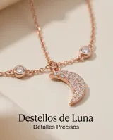 Collar doble de plata 925 con baño de oro rosa. La cadena superior presenta pequeñas circonias engastadas, mientras que la cadena inferior incluye un dije en forma de luna creciente pavé con circonias blancas.