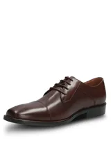 Zapato de vestir formal Hush Puppies modelo Jazz Brown, confeccionado en cuero marrón con diseño tipo oxford, cordones tono sobre tono y costuras decorativas.