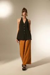 Pantalon de tiro alto confeccionado en eco-cuero, con diseño de pierna ancha y corte recto.