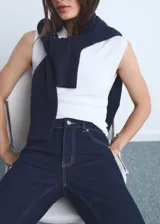 Jeans Sienna de tiro medio y corte flare con diseño crop, de tejido de algodón elástico en color azul oscuro, con cinco bolsillos, trabillas para cinturón, cierre de cremallera y botón, y bajo deshilachado.