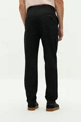 Pantalón chino de corte regular, confeccionado en tejido de algodón con elastano. Presenta cierre frontal con botón y cremallera, bolsillos laterales y traseros, y trabillas para cinturón.