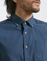 Camisa de manga larga con cuello button-down, bolsillo frontal y botones de madera. Confeccionada en una mezcla de poliéster y algodón.