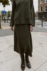 Falda midi de punto con textura suave y cintura elástica, de corte recto y diseño minimalista.