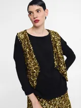 Chaleco sin mangas con frente cubierto de lentejuelas doradas y espalda en tela lisa negra. Presenta un corte abierto o tipo solapa frontal con un botón de ajuste.