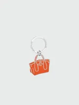 Llavero Longchamp con dije de bolso Le Roseau color naranja y aro metálico plateado con el nombre de la marca grabado.
