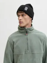 Gorro tipo beanie de punto color negro, con diseño acanalado y parche rectangular con logo de la marca en el frente.