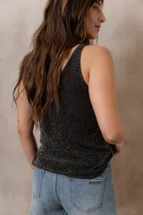 Musculosa de punto negro con efecto brillante, calce al cuerpo, escote en V y tirantes anchos.