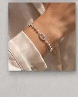 Pulsera de plata 925 compuesta por una cadena de eslabones tipo bolita intercalados con eslabones centrales ovalados y calados.