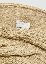 Bolso tipo saca de gran tamaño, confeccionado en tejido de lúrex brillante con acabado metalizado. Presenta un diseño minimalista sin cierre y una asa larga integrada para llevar al hombro.