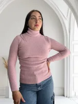 Polera rosada de cuello alto y mangas largas, confeccionada en tejido de punto acanalado.
