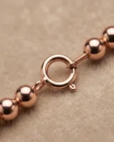 Pulsera de esferas pequeñas de plata 925 con baño en tono oro rosa.