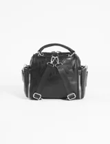 Mochila bandolera de cuero sintético color marrón, con múltiples compartimentos frontales y laterales con cierre metálico. Cuenta con asa superior y correas ajustables para usar como mochila o bandolera.