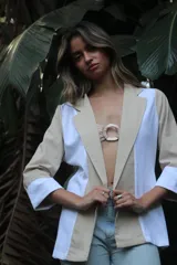 Chaqueta color beige con solapas y detalles en blanco.