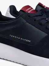 Zapatillas bajas Tommy Hilfiger de cuero napa color azul marino, con paneles texturizados, suela de EVA blanca dentada y detalles de la marca en el lateral y la lengüeta.