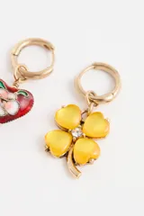Par de aros tipo argolla con dijes colgantes asimétricos: uno con forma de corazón esmaltado multicolor y otro con forma de trébol de cuatro hojas rojo con centro de cristal.