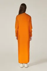 Túnica naranja de corte recto, con cuello mao, mangas 3/4 y cierre frontal con botones.