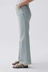 Jean celeste de calce recto, tiro medio-alto, lavado claro y ruedo desflecado.