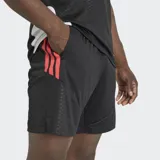 Short deportivo Adidas Tiro 26 Competition, color negro con detalles en rojo. Confeccionado en tejido interlock resistente con tecnología Climacool para mayor transpirabilidad. Presenta cintura elástica con cordón de ajuste y el logo de la marca en una de las piernas.