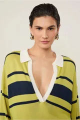 Top de punto de manga larga, largo medio, con escote en V profundo y cuello polo contrastante. Presenta bajo y puños acanalados.