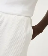 Bermuda masculina de color blanco con textura plisada, diseñada con cintura elástica para un ajuste cómodo y bolsillos traseros.