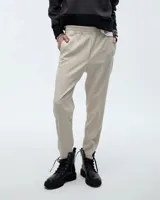 Babucha sastrera de tiro medio con cintura elastizada, bolsillos laterales funcionales y pierna tipo pitillo con raya de aplomo. Presenta un diseño elegante y estilizado.