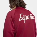 Campera deportiva Adidas de la selección de España, color bordó con las icónicas tres tiras blancas en las mangas. Presenta cuello chimenea, cierre frontal completo, bolsillos laterales y el logo del trébol junto al escudo de la selección en el pecho.