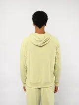 Canguro Umbro de felpa con capucha y cordones ajustables. Presenta el logo de la marca bordado en el pecho en color celeste y bolsillo frontal tipo canguro.