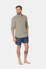 Short de baño clásico de color azul con estampado de veleros pequeños, cintura con elástico y cordón ajustable, dos bolsillos laterales y suspensor de malla fina en su interior.