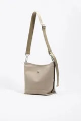 Bolso bandolera de tamaño pequeño confeccionado en nylon, con estructura blanda y cierre de cremallera. Cuenta con asa larga regulable de tejido y logo de la marca aplicado en la parte inferior frontal.