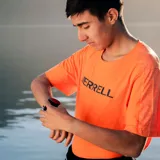 Remera deportiva de manga corta color naranja, con logo de la marca estampado en el frente. Confeccionada en tejido técnico elástico de secado rápido, ideal para actividades al aire libre.
