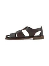 Sandalias de cuero marrón con diseño tipo franciscanas, combinadas con apliques de pelo con estampado animal print tipo vaca, hebilla metálica dorada de ajuste en el tobillo y suela plana.