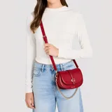 Bandolera Guess modelo Carrie Mini de color rojo, confeccionada en cuero sintético, con herrajes dorados y correa combinada de cadena metálica y tira ajustable. Presenta un diseño estructurado con solapa frontal, detalle de hebilla y el logo metálico de la marca.