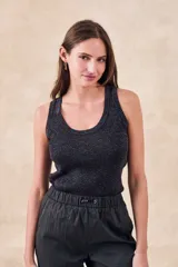 Top musculosa de punto acanalado color negro con hilos de lurex multicolor, escote redondo y corte ajustado al cuerpo.