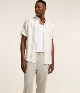 Pantalón masculino de corte relajado confeccionado en tejido oxford de algodón. Presenta cintura con trabillas y lazo ajustable, bolsillos laterales y traseros.