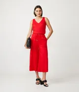 Conjunto de top y pantalón pantacourt rojos. El top es sin mangas, con escote en V y corte a la cintura. El pantalón es de tiro alto, con cintura elastizada y lazo ajustable.