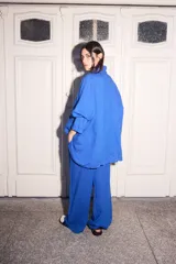 Blazer azul de lino con corte holgado, solapas y cuatro botones fucsia.