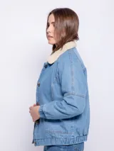 Campera de jean color blanco con corderito en el cuello y en el interior. Cuenta con dos bolsillos en la parte delantera, botones metálicos y elástico en el bajo.