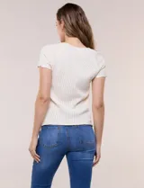 Blusa de punto calado color blanco, de silueta entallada, manga corta raglán y escote redondo, con detalles de tejido fantasía en el canesú y terminaciones festonadas.