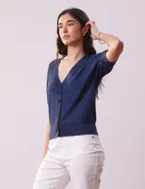 Cárdigan blanco tejido con escote en V, abertura frontal con botones y mangas cortas abullonadas con puño.