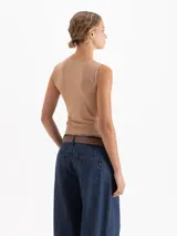 Musculosa de cuello redondo y silueta minimalista, confeccionada en una suave mezcla de poliamida y elastano que ofrece un calce confortable y una gran adaptabilidad al cuerpo. Su diseño sin mangas con hombros sutilmente encajados la convierte en una prenda básica de alta calidad.
