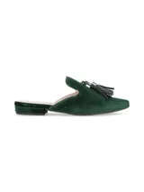 Zueco plano de terciopelo verde oscuro, con diseño destalonado, punta fina y detalle de borla decorativa en el empeine.
