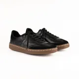 Championes de estilo urbano con diseño combinado en cuero negro y paneles laterales con estampado animal print tipo leopardo. Presenta detalle en color dorado en el talón, cierre con cordones negros y suela de goma en tono natural.
