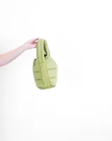 Bolsito tipo tote acolchado de color amarillo, con diseño de líneas horizontales y logo de la marca estampado en el frente. Cuenta con dos asas superiores acolchadas y una correa ajustable de cinta en color beige.